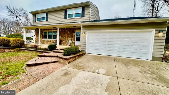 a view of a house with swimming pool and sitting area