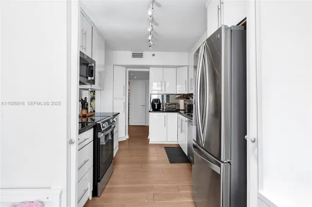 a kitchen with stainless steel appliances a refrigerator and a stove
