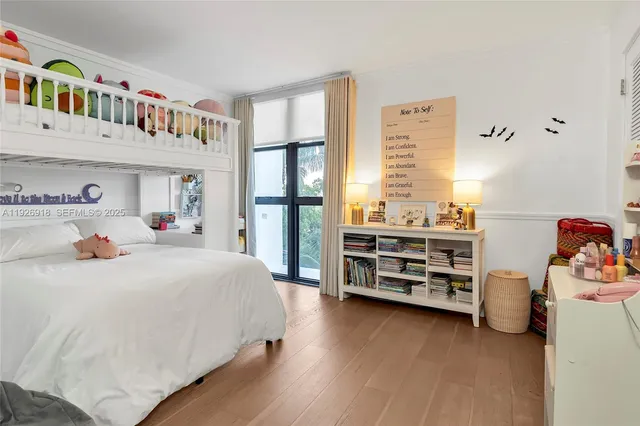 a bedroom with a bed a dresser and a book shelf