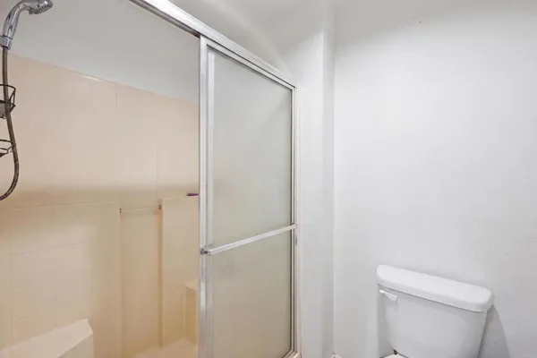 a bathroom with a shower and a toilet