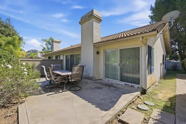 a view of a patio with a table and chairs
