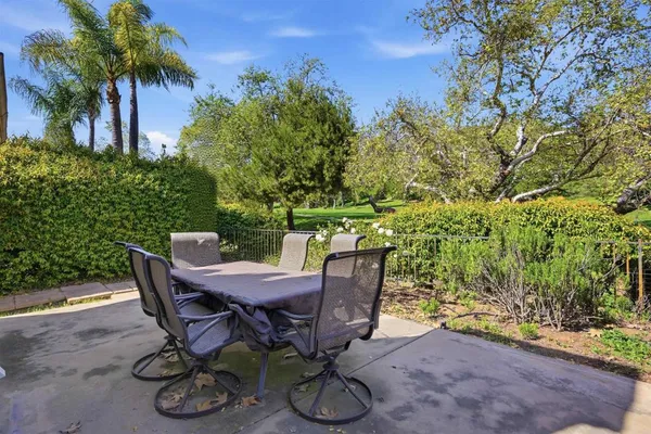 a view of a backyard with furniture and a garden