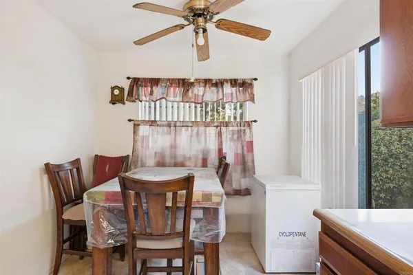 a view of a dining room with furniture and a chandelier