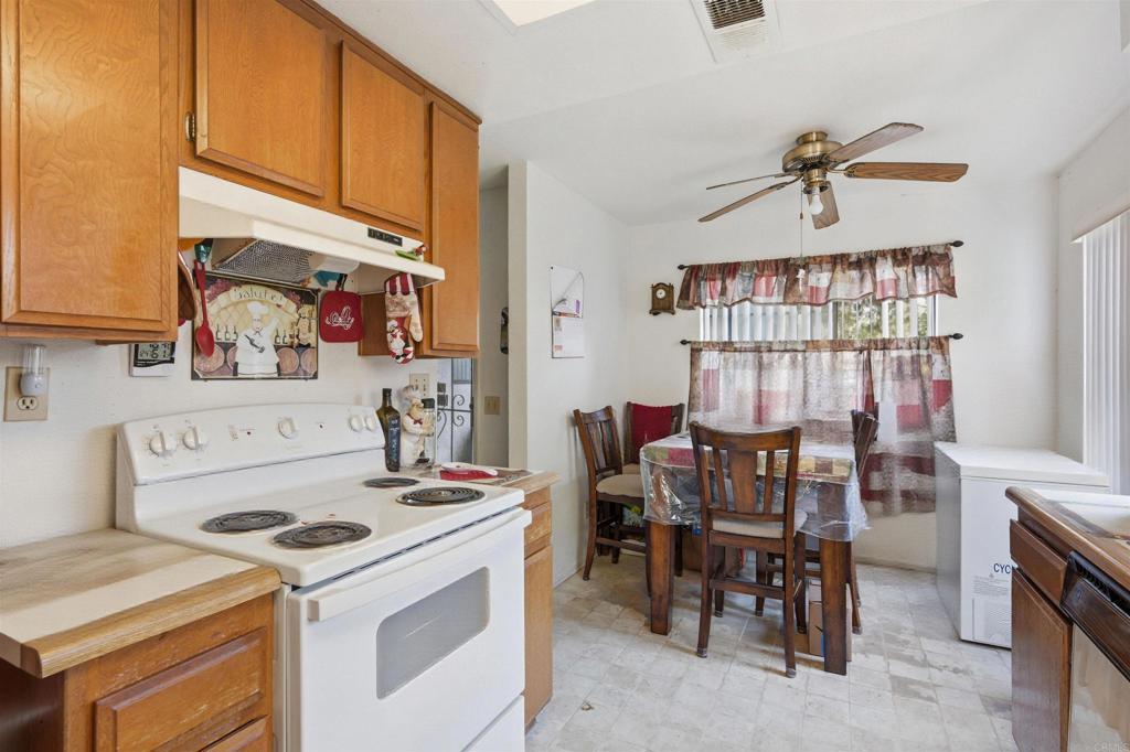 4308 Los Padres Drive Fallbrook, CA 92028 - Photo 7 of 21 a kitchen that has a stove a table and chairs in it
