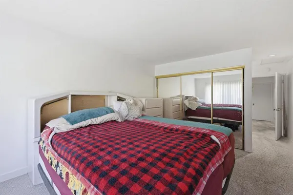 a bedroom with double bed and a large mirror