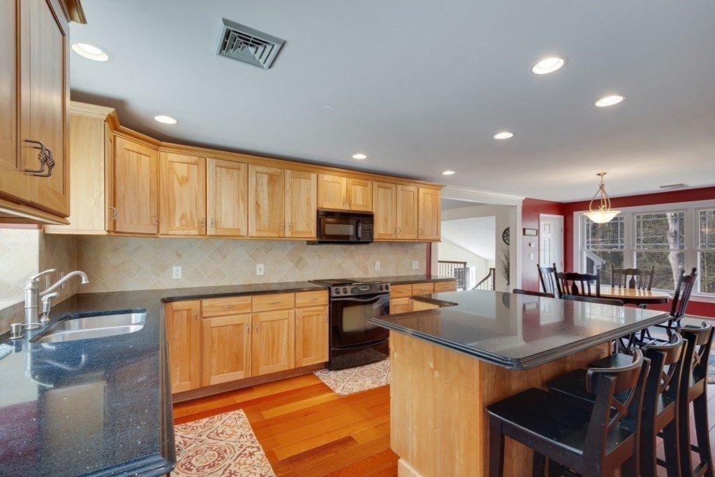 233 Ashburnham State Road Westminster, MA 01473 - Photo 17 of 42 a kitchen with stainless steel appliances granite countertop a sink a stove counter space and cabinets