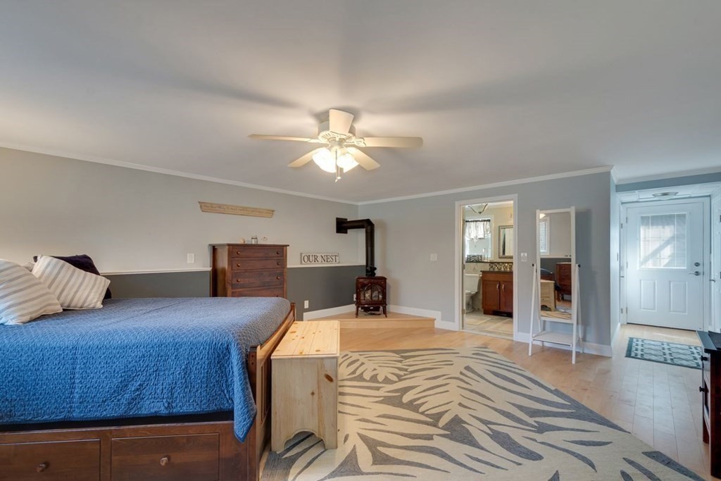 233 Ashburnham State Road Westminster, MA 01473 - Photo 22 of 42 a bedroom with a large bed and chandelier fan