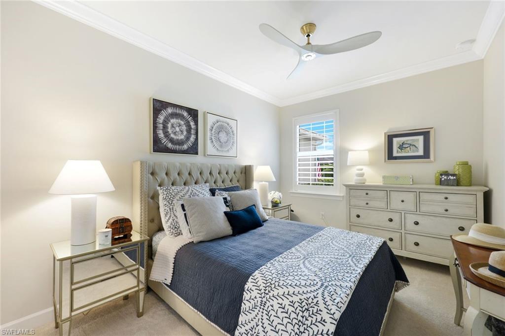 10763 Manatee Key Lane Estero, FL 33928 - Photo 13 of 33 a bedroom with a bed and a lamp on dresser