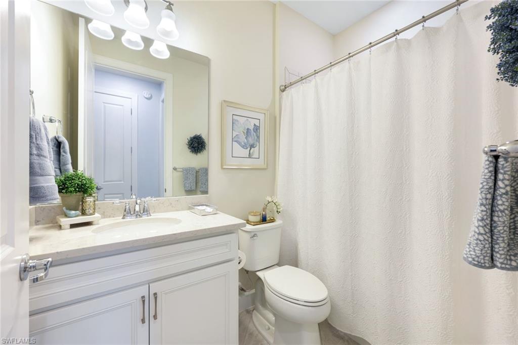 10763 Manatee Key Lane Estero, FL 33928 - Photo 14 of 33 a bathroom with a sink a toilet and a mirror