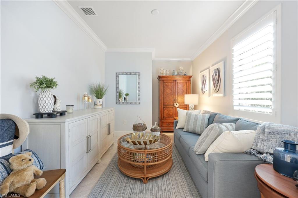 10763 Manatee Key Lane Estero, FL 33928 - Photo 15 of 33 a living room with furniture and a potted plant