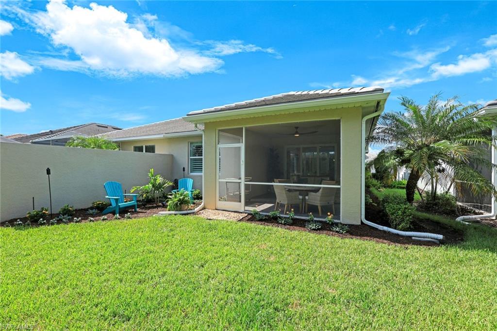 10763 Manatee Key Lane Estero, FL 33928 - Photo 19 of 33 a front view of a house with garden