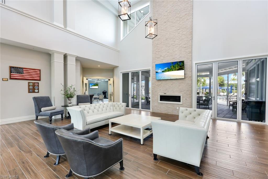 10763 Manatee Key Lane Estero, FL 33928 - Photo 24 of 33 a living room with fireplace furniture and a flat screen tv