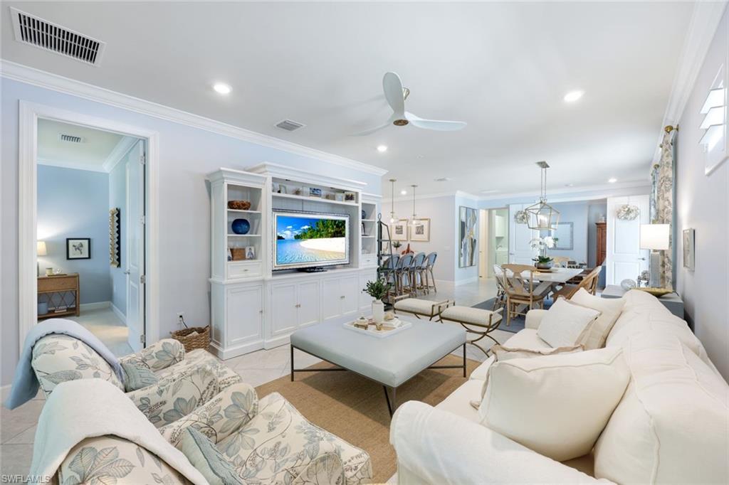 10763 Manatee Key Lane Estero, FL 33928 - Photo 4 of 33 a living room with furniture and a large mirror