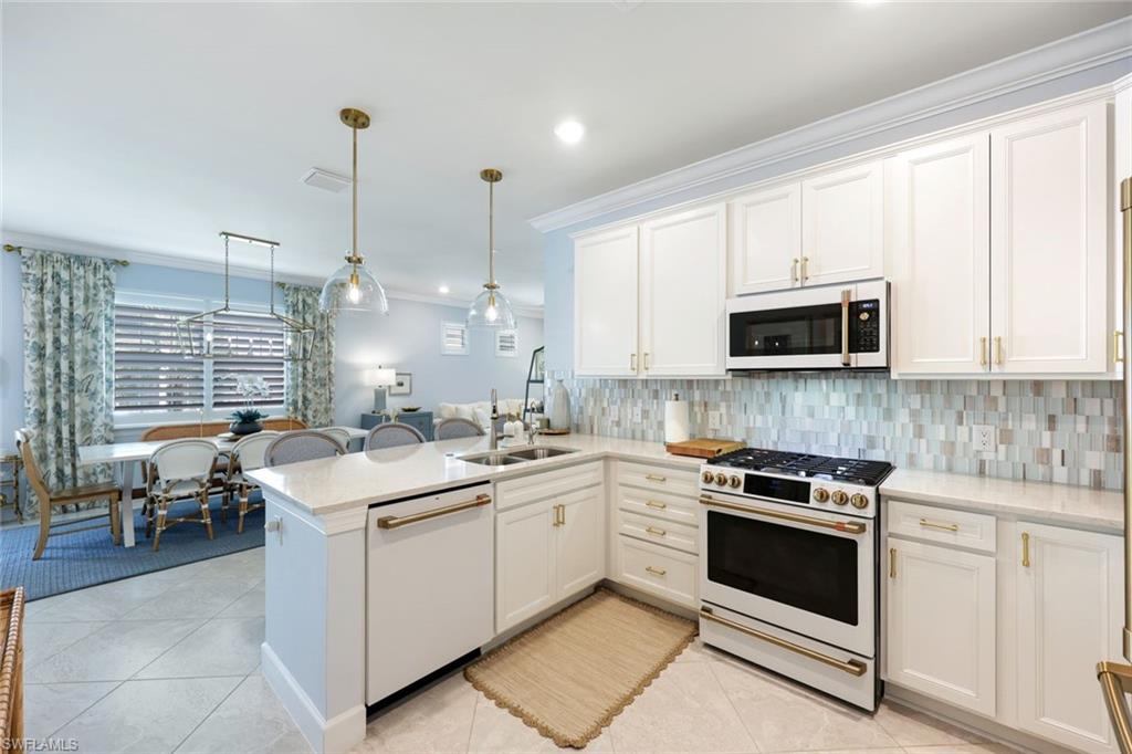 10763 Manatee Key Lane Estero, FL 33928 - Photo 6 of 33 a kitchen with a sink stove and microwave