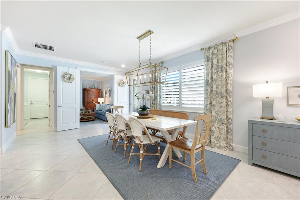10763 Manatee Key Lane Estero, FL 33928 - Photo 8 of 33 a view of a dining room and livingroom with furniture wooden floor a chandelier