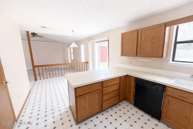 a kitchen with a sink a stove and cabinets