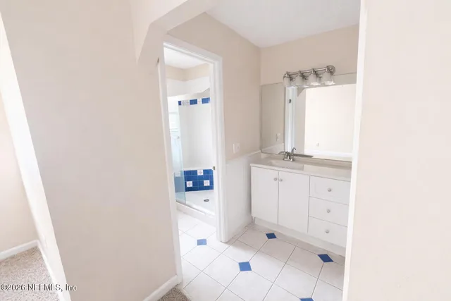 a bathroom with a bathtub sink and mirror