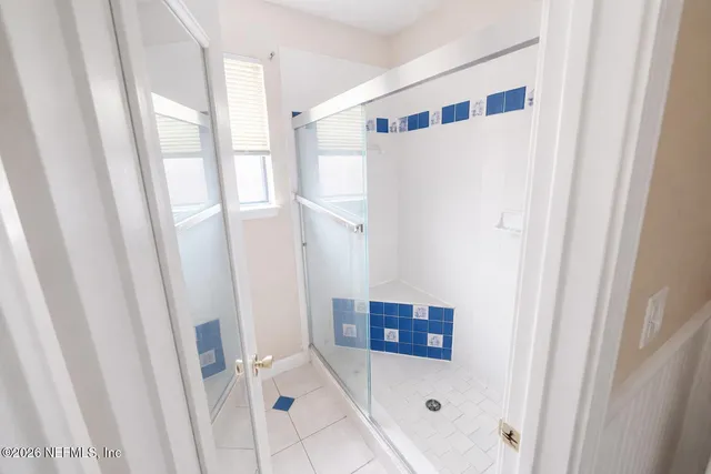 a bathroom with a shower and a sink