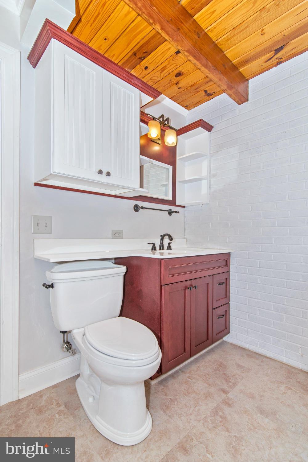 20580 Park Hall Road Rohrersville, MD 21779 - Photo 22 of 30 a bathroom with a sink a toilet and vanity