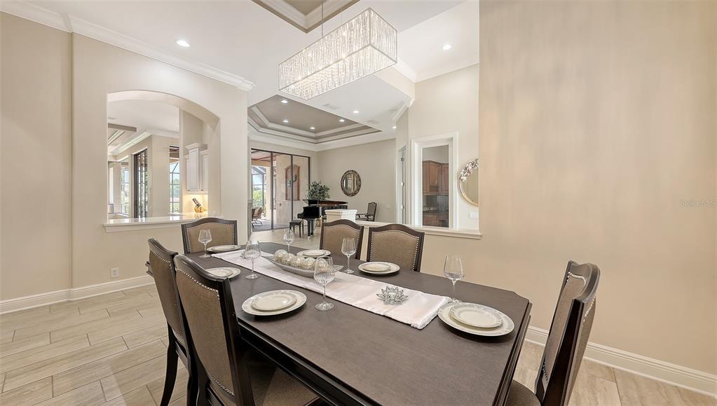 6919 Dominion Lane Lakewood Ranch, FL 34202 - Photo 11 of 99 a dining room with furniture and wooden floor