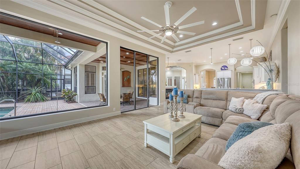 6919 Dominion Lane Lakewood Ranch, FL 34202 - Photo 18 of 99 a living room with furniture and a large window