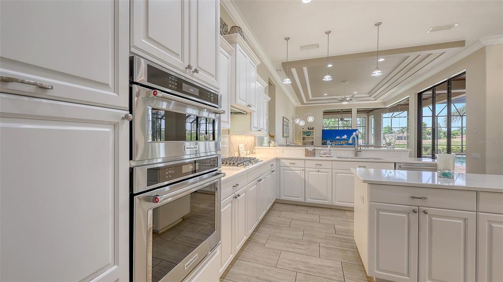 6919 Dominion Lane Lakewood Ranch, FL 34202 - Photo 23 of 99 a kitchen with stainless steel appliances granite countertop a refrigerator and a sink