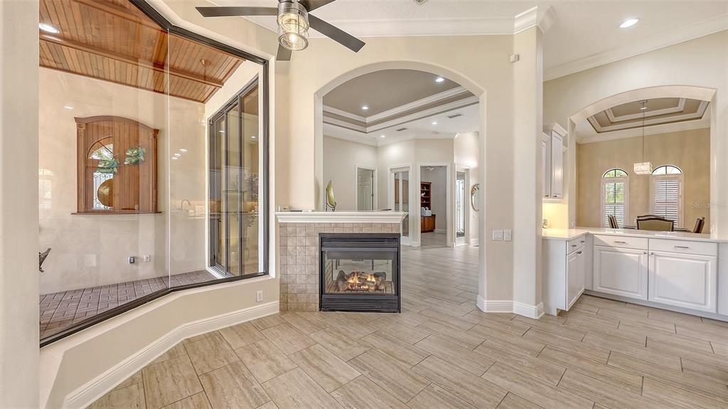6919 Dominion Lane Lakewood Ranch, FL 34202 - Photo 28 of 99 a view of a hallway view with wooden floor and a fireplace