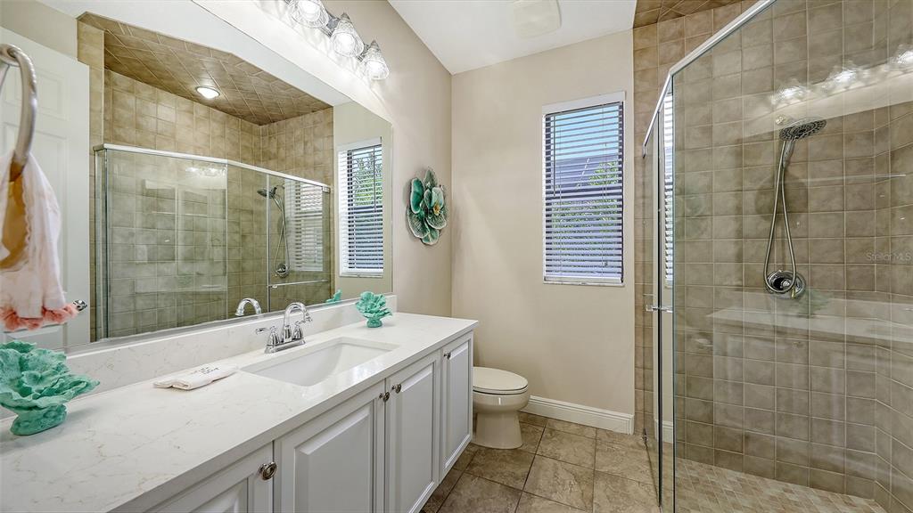 6919 Dominion Lane Lakewood Ranch, FL 34202 - Photo 42 of 99 a bathroom with a double vanity sink toilet and shower