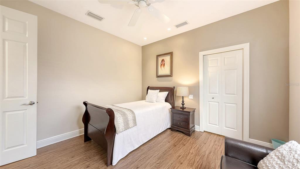 6919 Dominion Lane Lakewood Ranch, FL 34202 - Photo 45 of 99 a bedroom with a bed and a couch