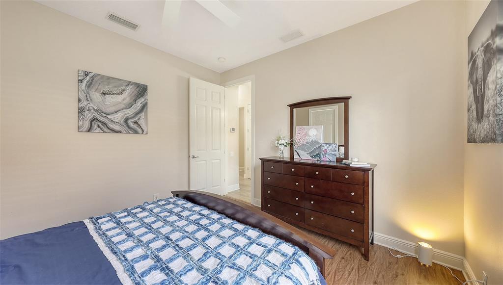 6919 Dominion Lane Lakewood Ranch, FL 34202 - Photo 49 of 99 a bedroom with a bed and a window