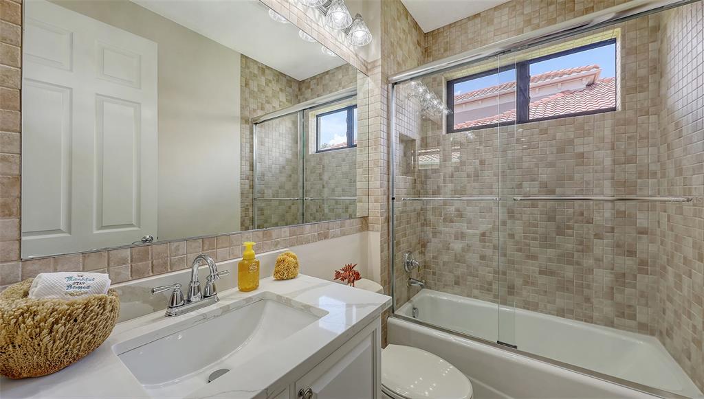 6919 Dominion Lane Lakewood Ranch, FL 34202 - Photo 51 of 99 a bathroom with a sink a toilet and shower