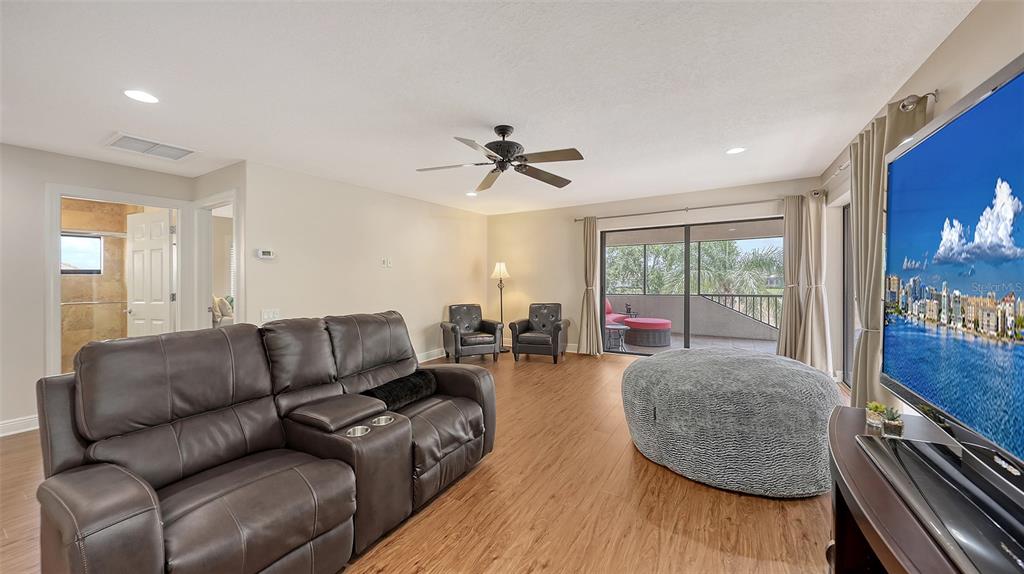 6919 Dominion Lane Lakewood Ranch, FL 34202 - Photo 58 of 99 a living room with furniture and a large window