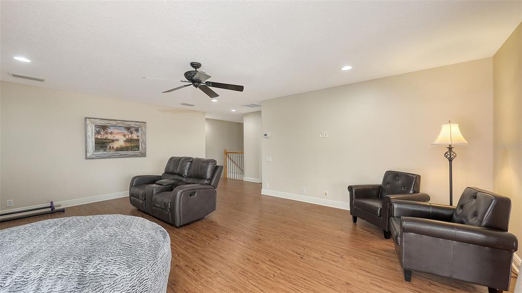 6919 Dominion Lane Lakewood Ranch, FL 34202 - Photo 59 of 99 a living room with furniture and a flat screen tv