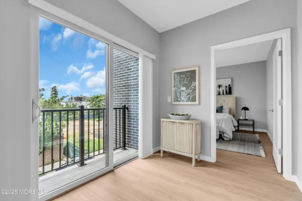a view of a room with gym equipment and floor to ceiling window