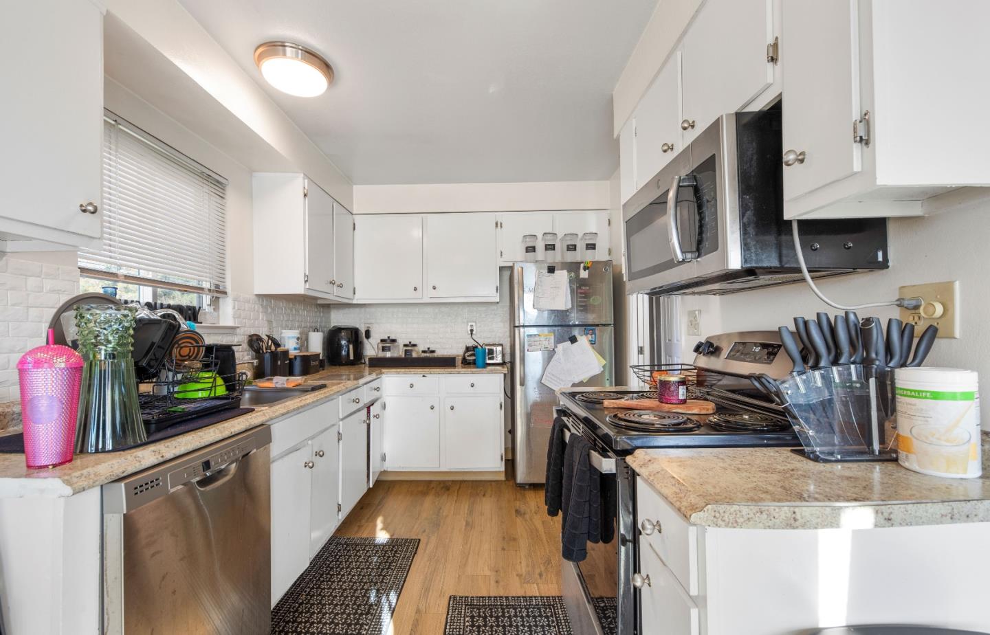 46 Grass Court Novato, CA 94949 - Photo 14 of 21 a kitchen with stainless steel appliances granite countertop a sink stove and refrigerator