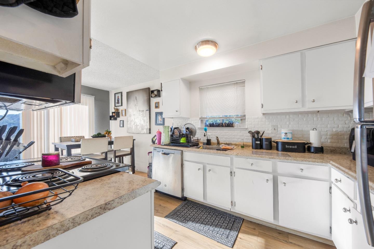 46 Grass Court Novato, CA 94949 - Photo 15 of 21 a kitchen with stainless steel appliances kitchen island granite countertop a sink cabinets and a window