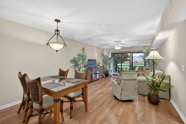 a living room with furniture a chandelier a flat screen tv and a large window