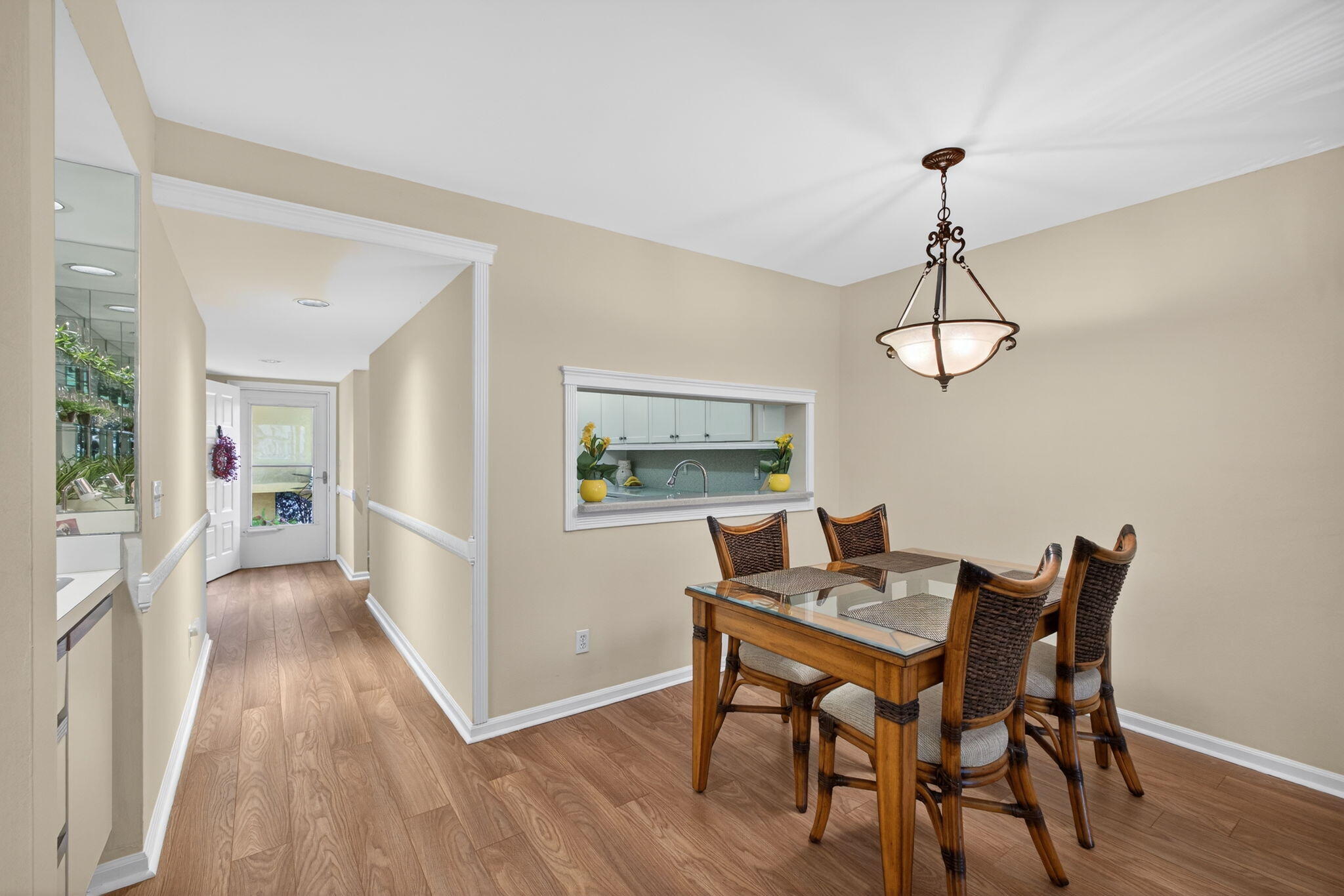 2041 Keystone Drive, Unit F Jupiter, FL 33458 - Photo 20 of 63 a view of a dining room with furniture wooden floor and a chandelier