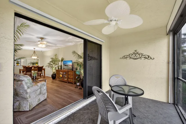 a view of swimming pool with outdoor seating and a patio