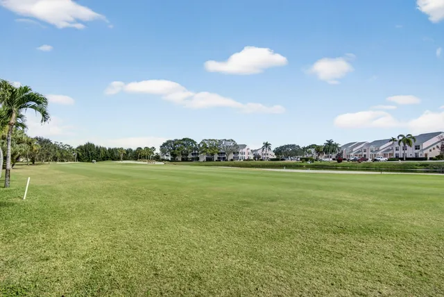 a kitchen with a sink a stove a oven a dining table and chairs