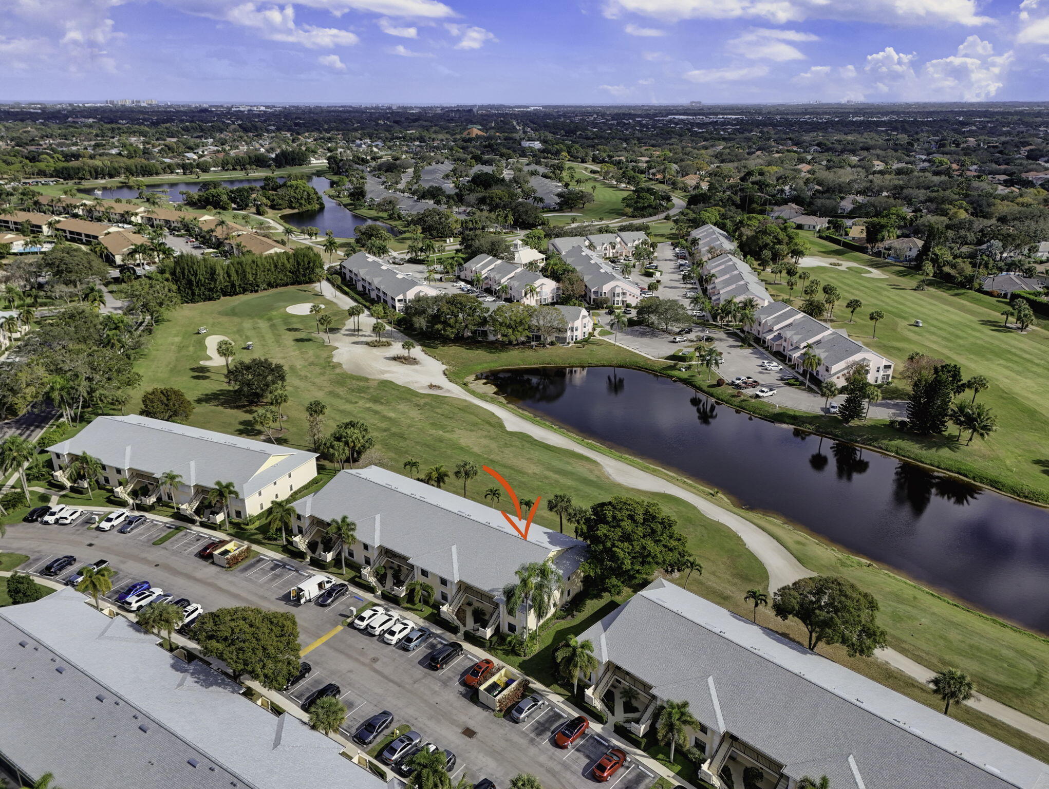 2041 Keystone Drive, Unit F Jupiter, FL 33458 - Photo 53 of 63 an aerial view of a city with lots of residential buildings and mountain view in back
