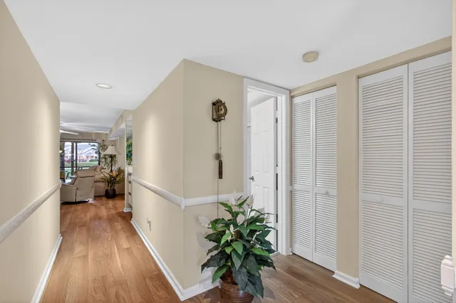 a living room with furniture large window and wooden floor