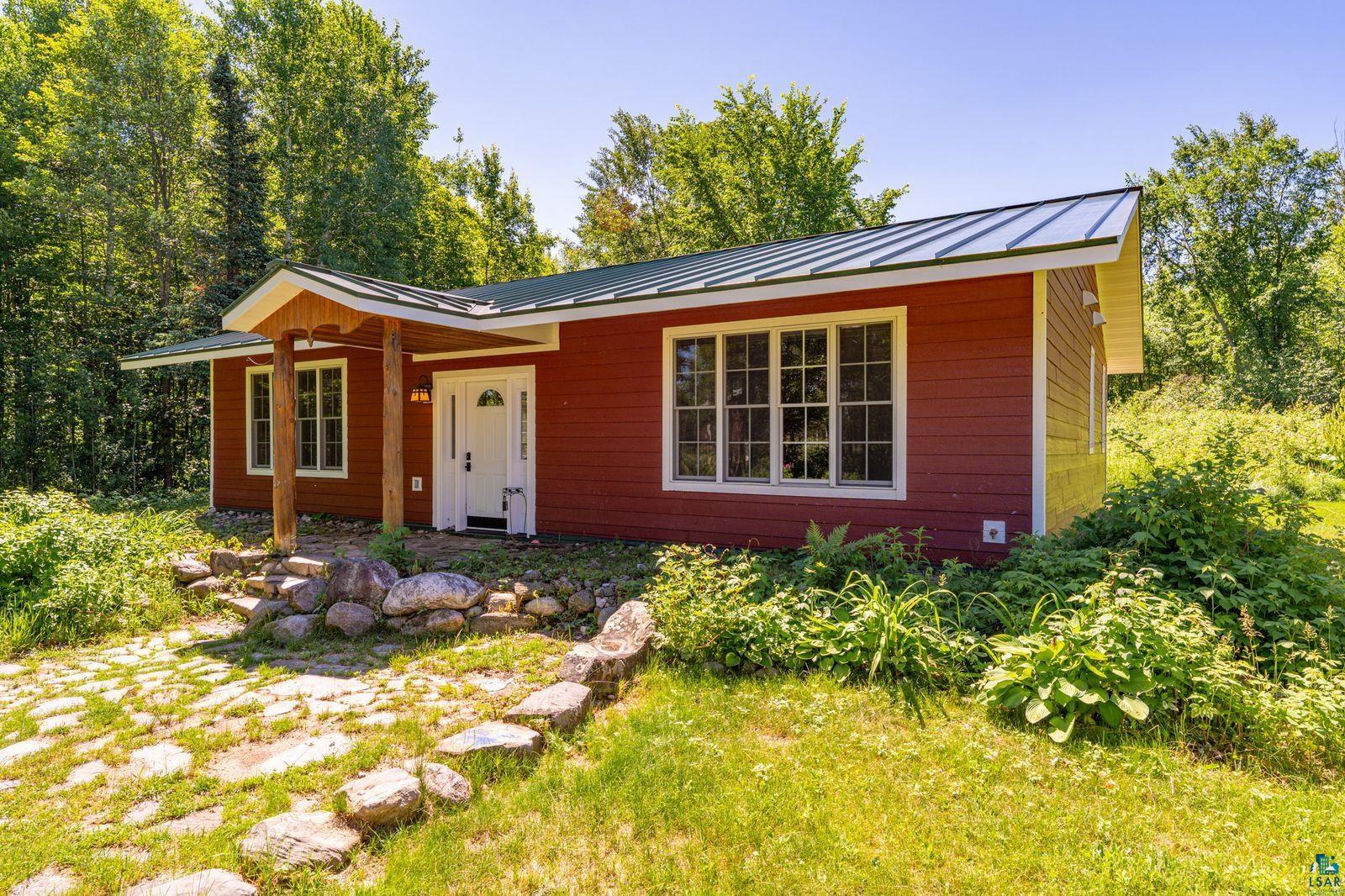9734 Alango Road Angora, MN 55703 - Photo 2 of 41 Red siding exterior with a green metal roof