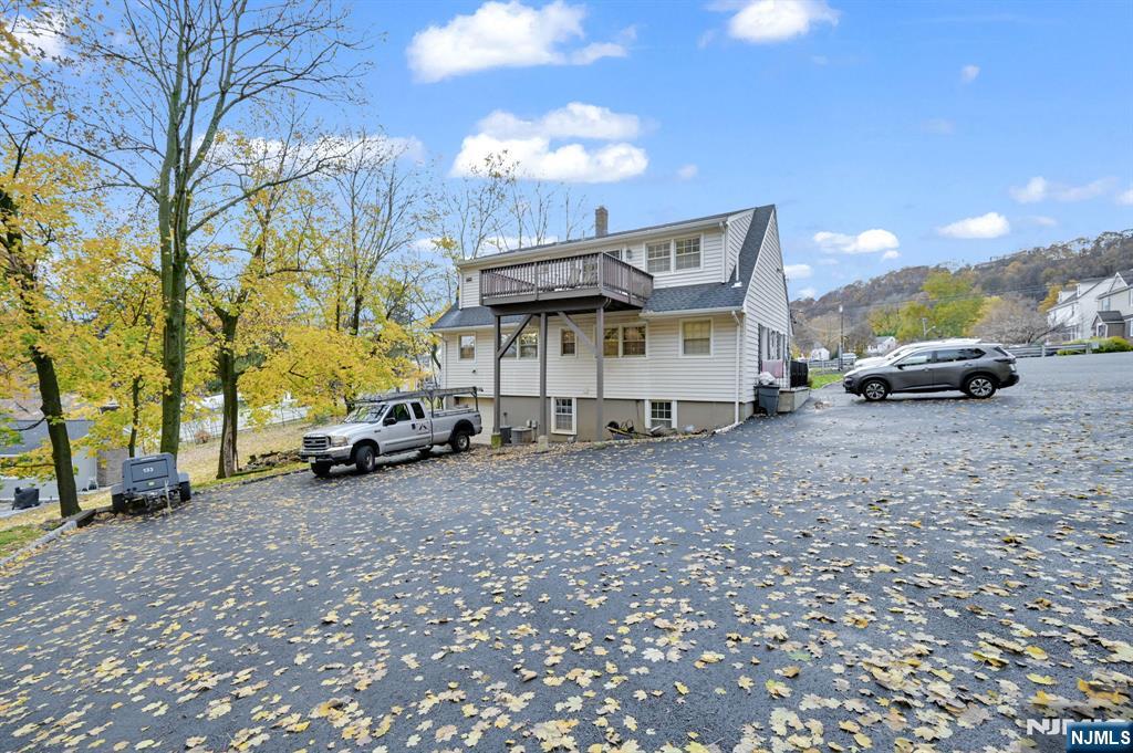 857 Pompton Avenue Cedar Grove, NJ 07009 - Photo 3 of 16 a view of a house with a yard and parking