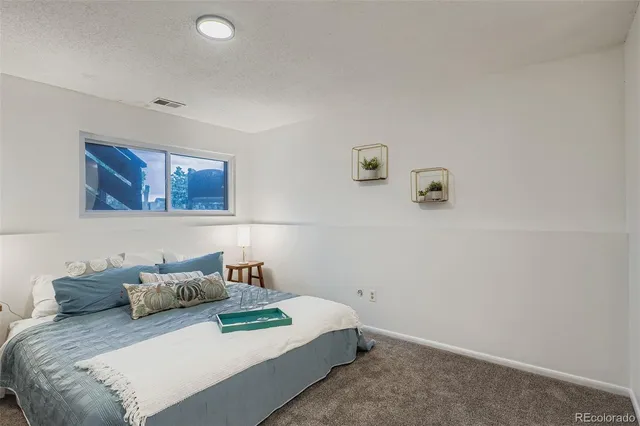 a bedroom with a bed and cabinets