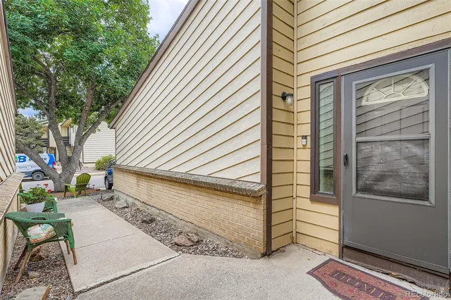 a view of house with backyard and sitting area