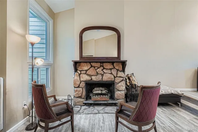 a living room with furniture a fireplace and a table