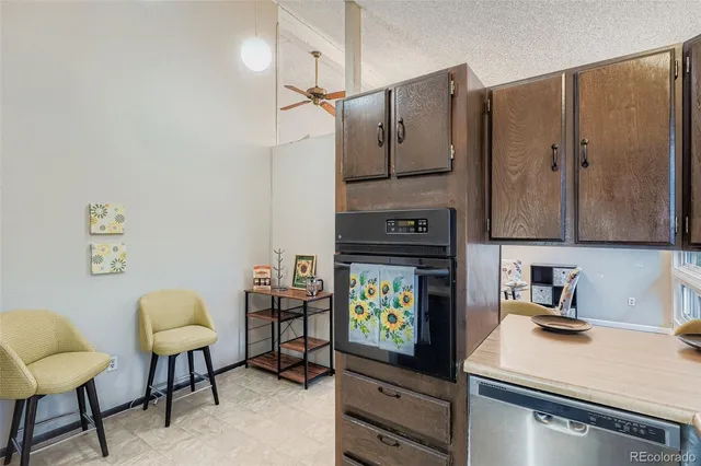 a kitchen with stainless steel appliances granite countertop a sink refrigerator and cabinets
