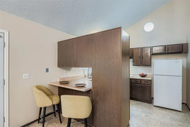 a kitchen with stainless steel appliances a refrigerator and a stove