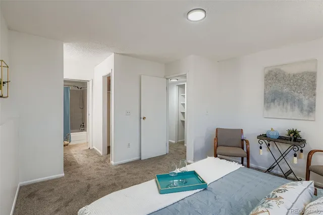 a bedroom with a bed and a table in it